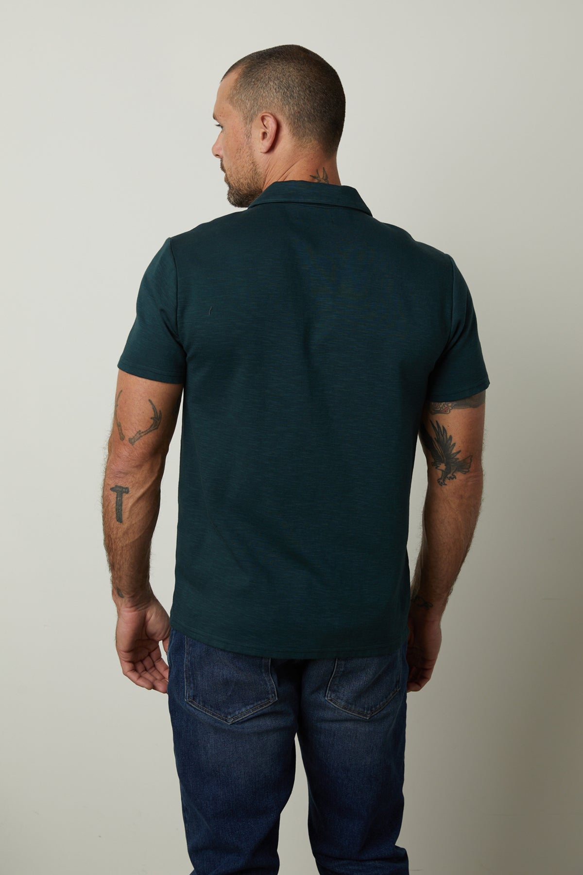   The back view of a man wearing a Velvet by Graham & Spencer DILAN COTTON BLEND POLO shirt. 