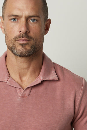 A man wearing a Velvet by Graham & Spencer DILAN COTTON BLEND POLO shirt.