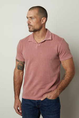 A man wearing a Velvet by Graham & Spencer Dilan Cotton Blend Polo shirt and jeans.