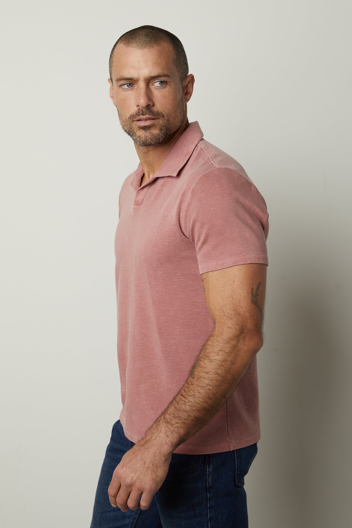 A man wearing a Velvet by Graham & Spencer DILAN COTTON BLEND POLO shirt and jeans.-26827671666881