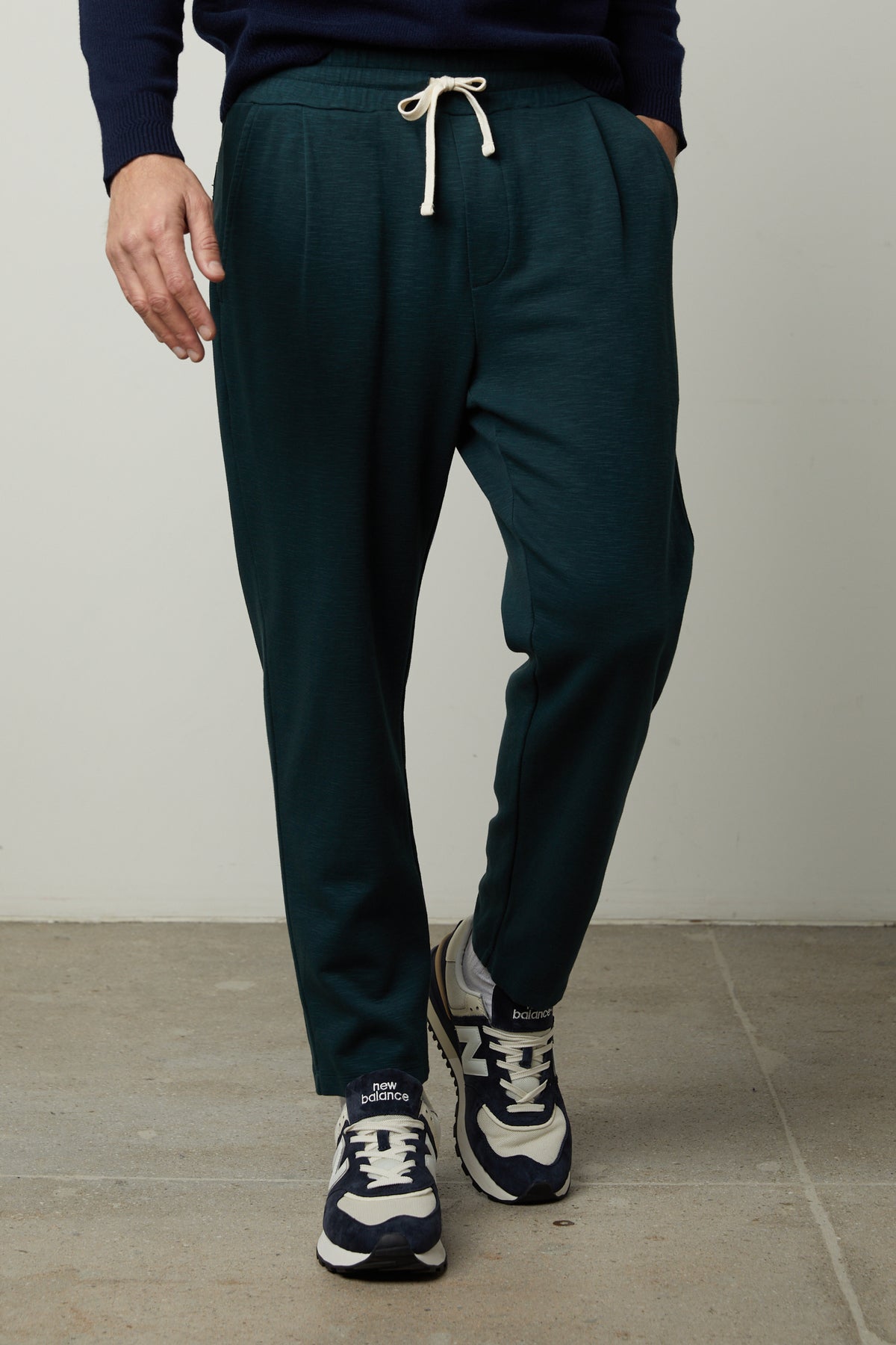   A man wearing a Velvet by Graham & Spencer PARKER SWEATPANT and sneakers. 