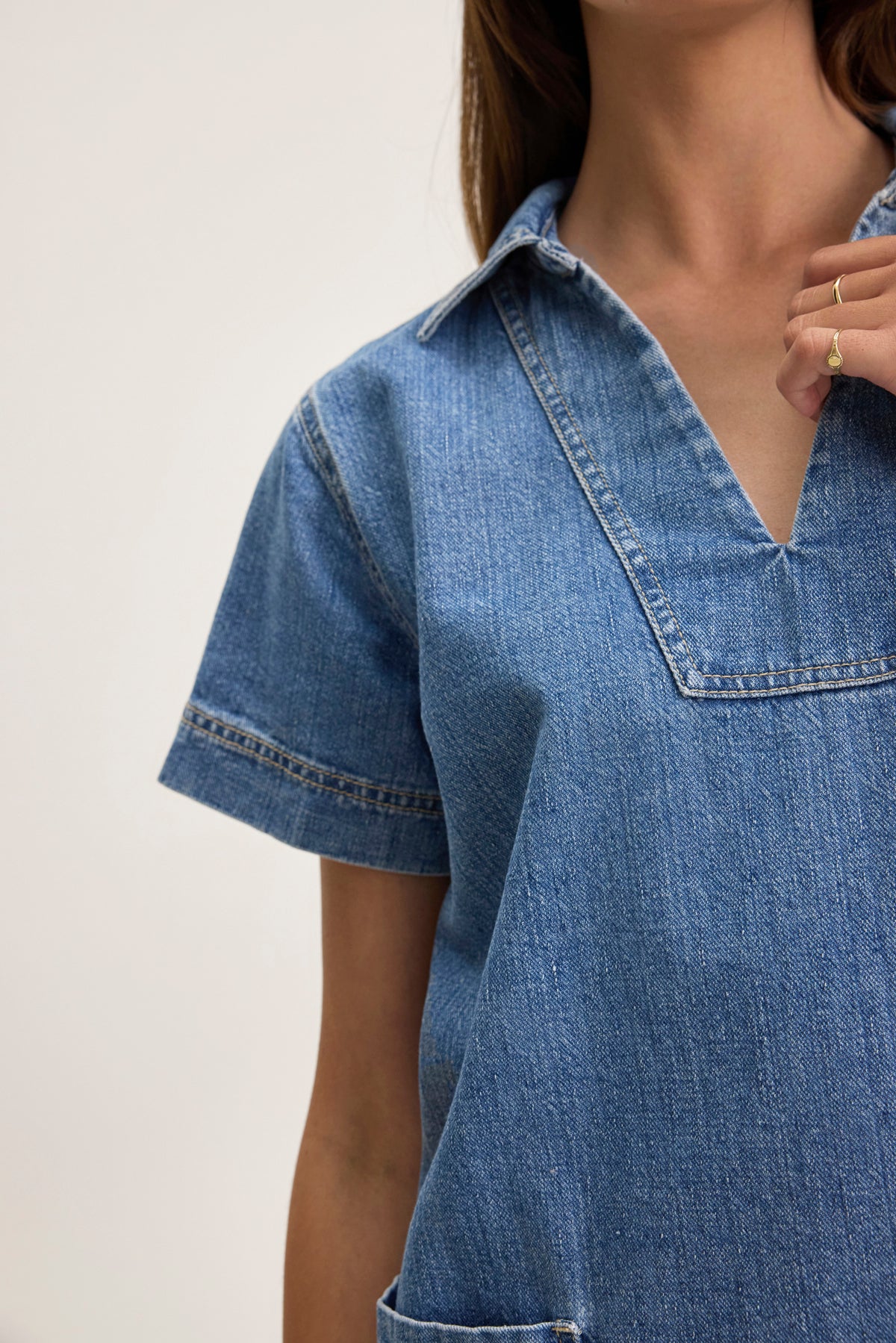 Someone wearing the DELANA DENIM DRESS by Velvet by Graham & Spencer, featuring short sleeves, a V-neck, and a collar, against a plain background.-38802060050625