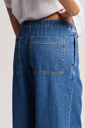 Model wears the SYD JEAN by Velvet by Graham & Spencer—relaxed fit, wide-leg denim with an elastic drawstring waist—paired with a white top, shown from the back waist down.