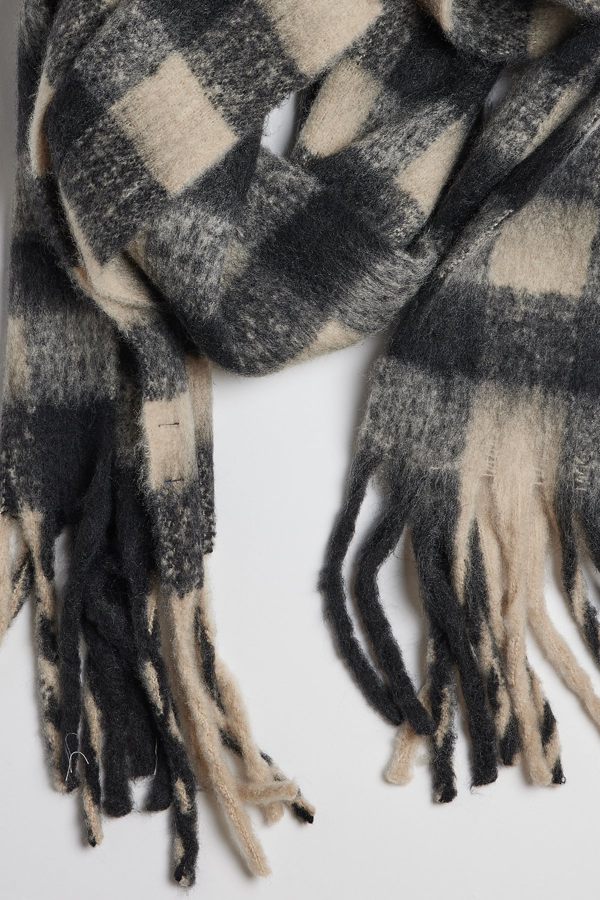   A classic ELLE PLAID SCARF by Velvet by Graham & Spencer with fringe ends that provides both warmth and comfort. 
