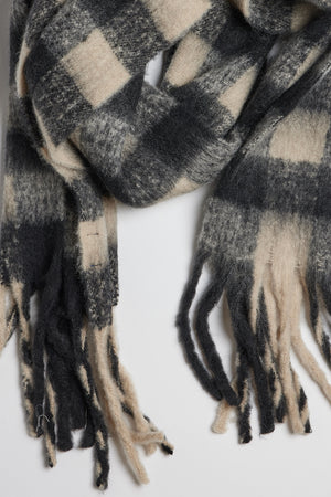 A classic ELLE PLAID SCARF by Velvet by Graham & Spencer with fringe ends that provides both warmth and comfort.