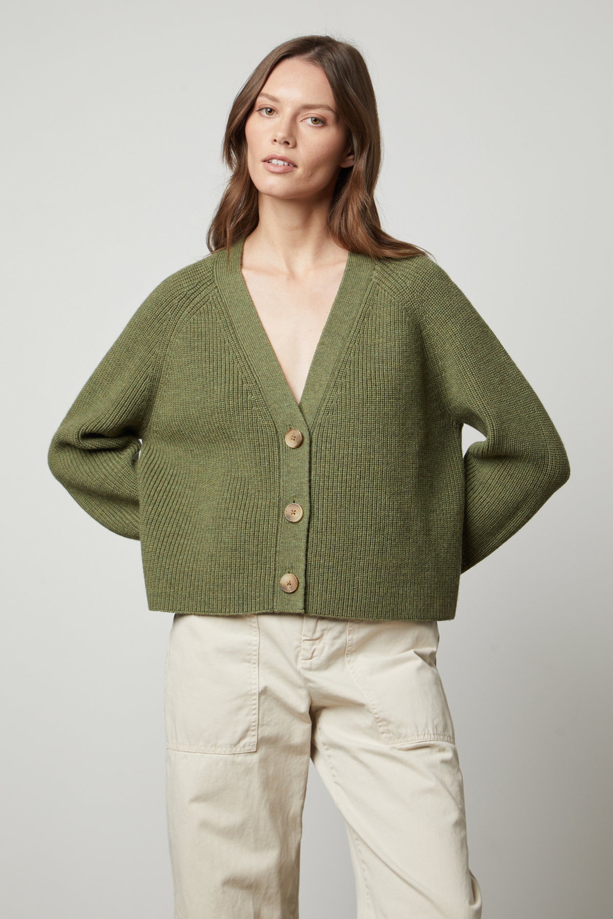   The model is wearing the Marilyn Button Front Cardigan from Velvet by Graham & Spencer, made of wool blend for warmth and comfort, featuring jumbo buttons. 