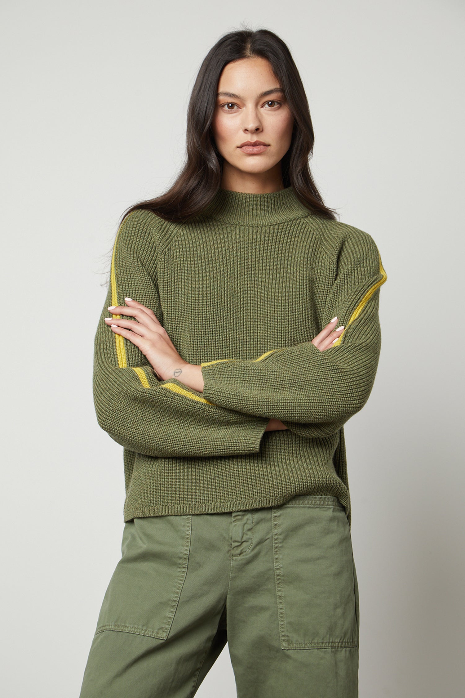   The model is wearing a comfortable Velvet by Graham & Spencer TEAGAN MOCK NECK SWEATER with yellow stripes. 