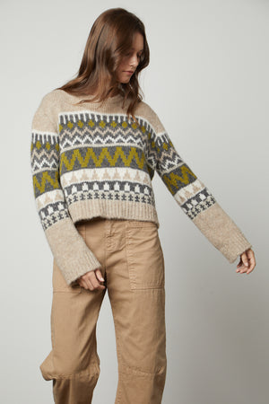 The model is wearing a cozy Velvet by Graham & Spencer MAKENZIE ALPACA CABLE KNIT CREW NECK SWEATER.