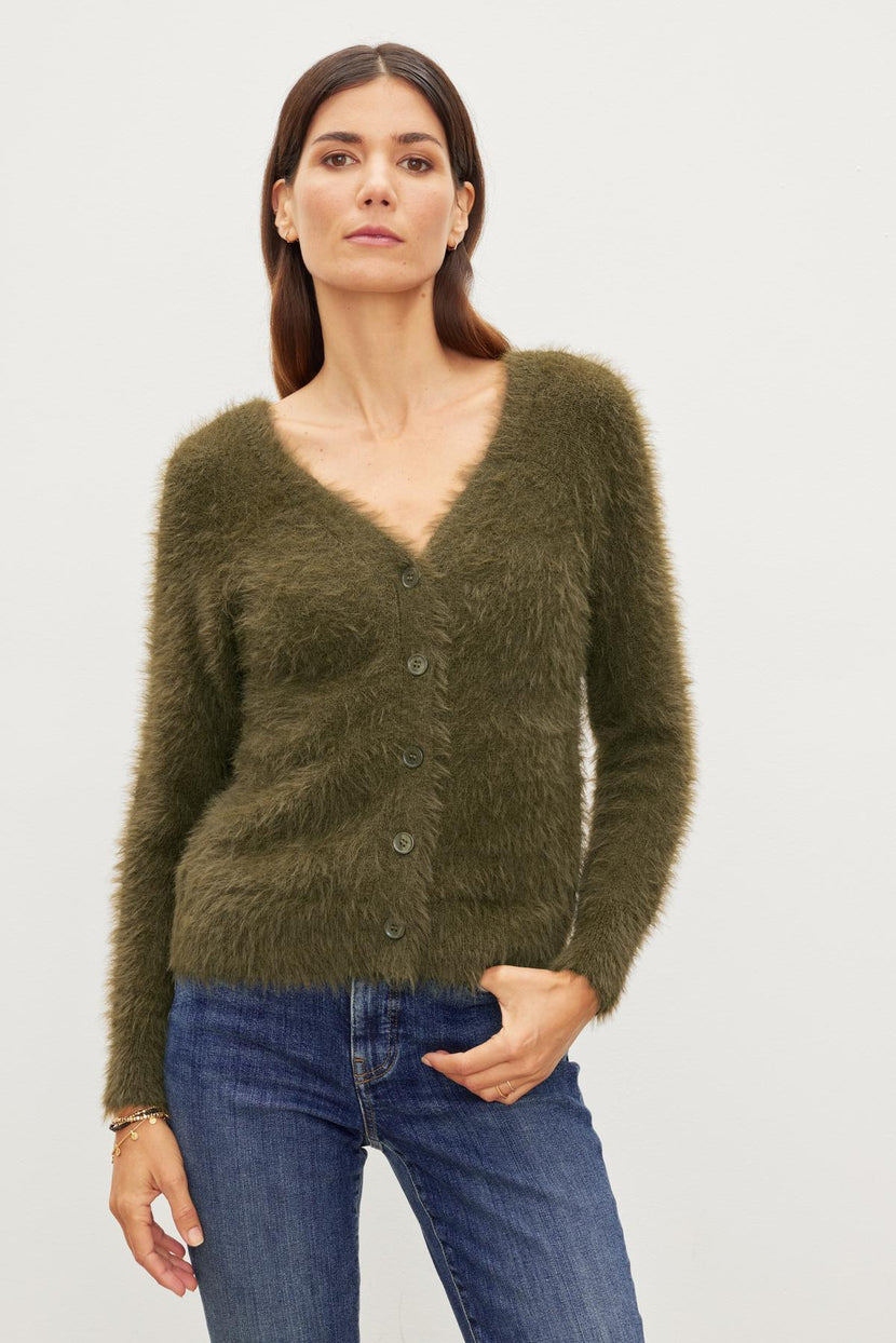 A woman wearing the Velvet by Graham & Spencer ELLE FEATHER YARN CARDIGAN.