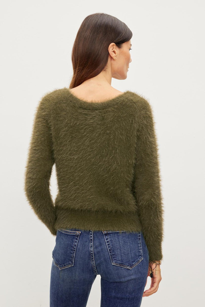 The woman's back view showcases her versatile ELLE FEATHER YARN CARDIGAN made by Velvet by Graham & Spencer.