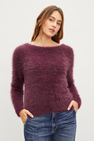 An ELLE FEATHER YARN CARDIGAN by Velvet by Graham & Spencer makes for a versatile wardrobe addition.