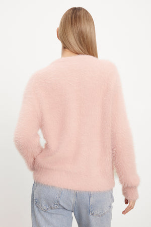 The back view of a woman wearing a Velvet by Graham & Spencer KELSEY FEATHER YARN CARDIGAN.