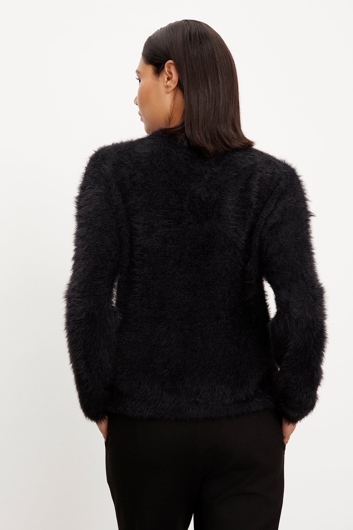   The back view of a woman wearing a Velvet by Graham & Spencer RAY FEATHER YARN CREW NECK SWEATER. 