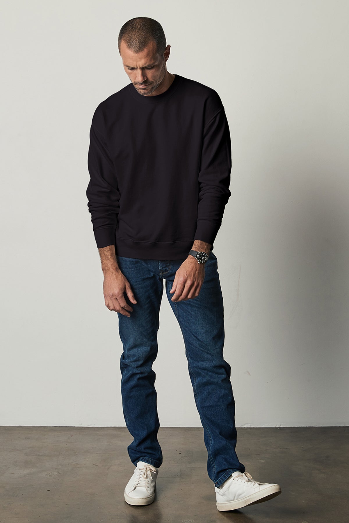 Sirus Crew Neck Sweatshirt in black with blue denim and sneakers full length front-26496370540737