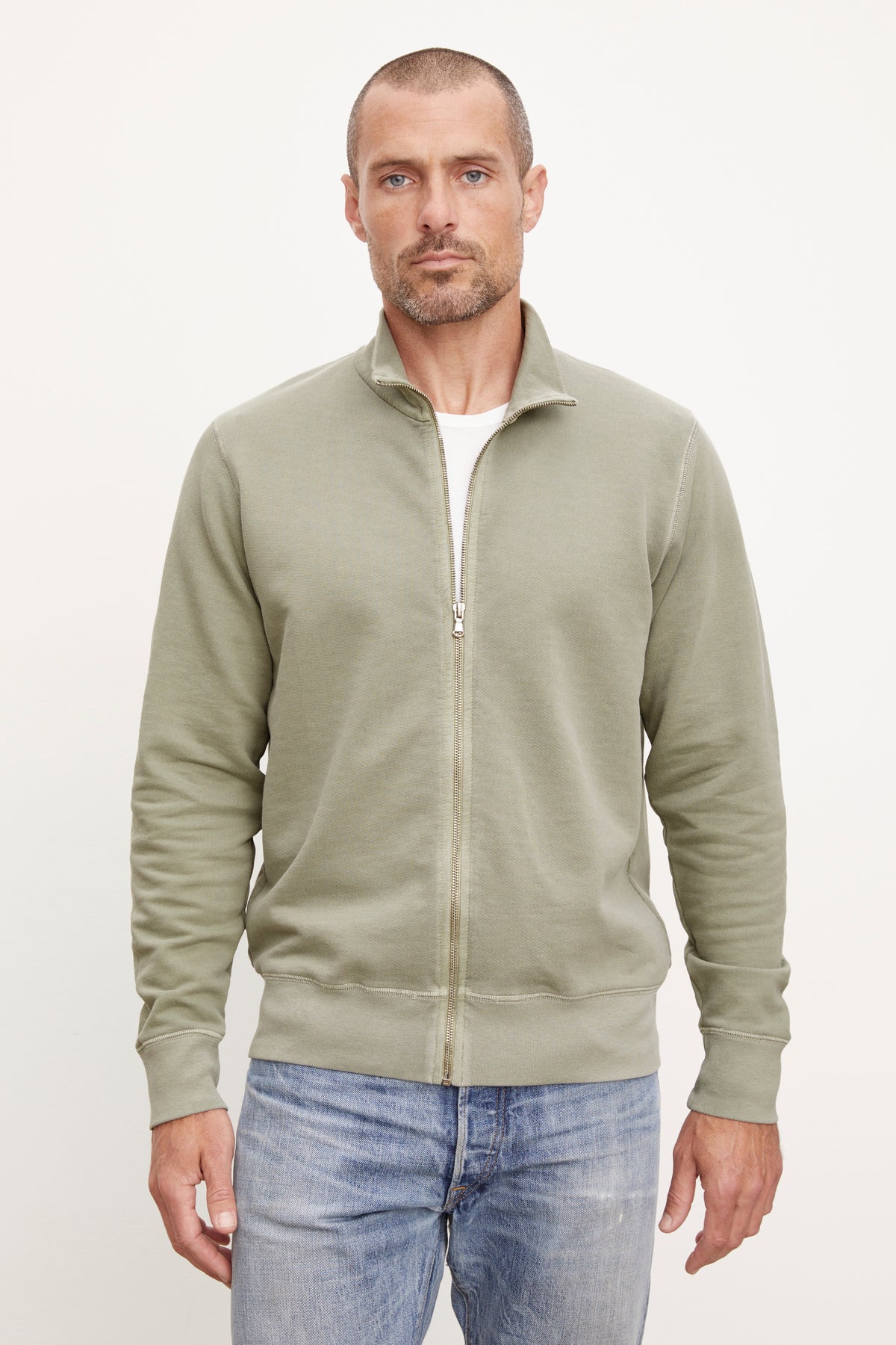  A man wearing a green Velvet by Graham & Spencer TERRY FRENCH TERRY FULL-ZIP sweatshirt. 