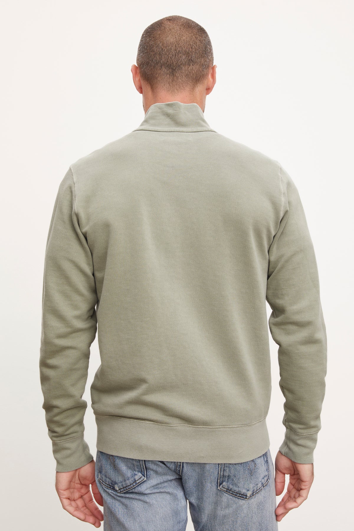   The back view of a man wearing a green Velvet by Graham & Spencer TERRY FRENCH TERRY FULL-ZIP sweatshirt. 