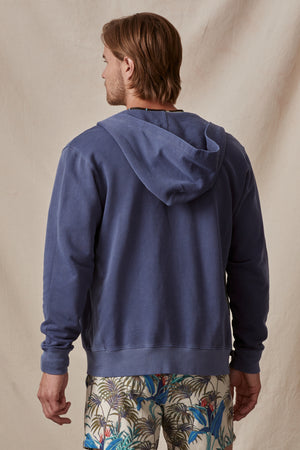 Man from behind wearing a Velvet by Graham & Spencer VINCENT HOODIE and patterned shorts, standing against a neutral backdrop.