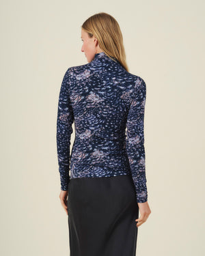 Back view of the TAYLOR PRINTED TEE by Velvet by Graham & Spencer, a long-sleeved mock neck jersey featuring a dark blue pattern of scattered, feathery shapes in shades of pink and white.