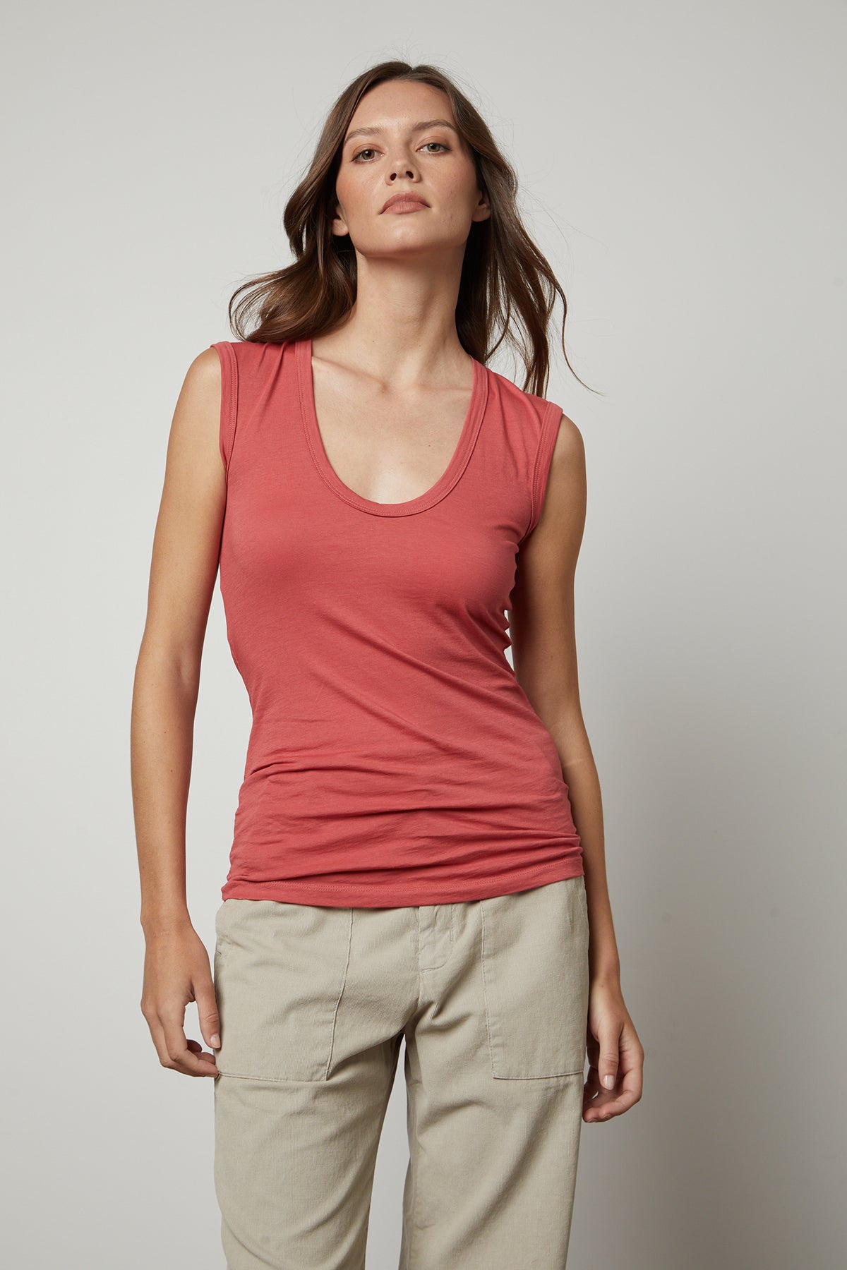 A woman wearing a Velvet by Graham & Spencer ESTINA GAUZY WHISPER FITTED TANK TOP and khaki pants.-35782798016705
