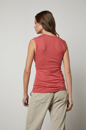 The back view of a woman wearing a Velvet by Graham & Spencer ESTINA GAUZY WHISPER FITTED TANK TOP and khaki pants.