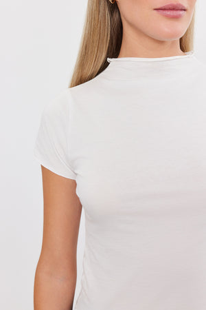 A woman wearing a Velvet by Graham & Spencer Jackie Mock Neck Tee.