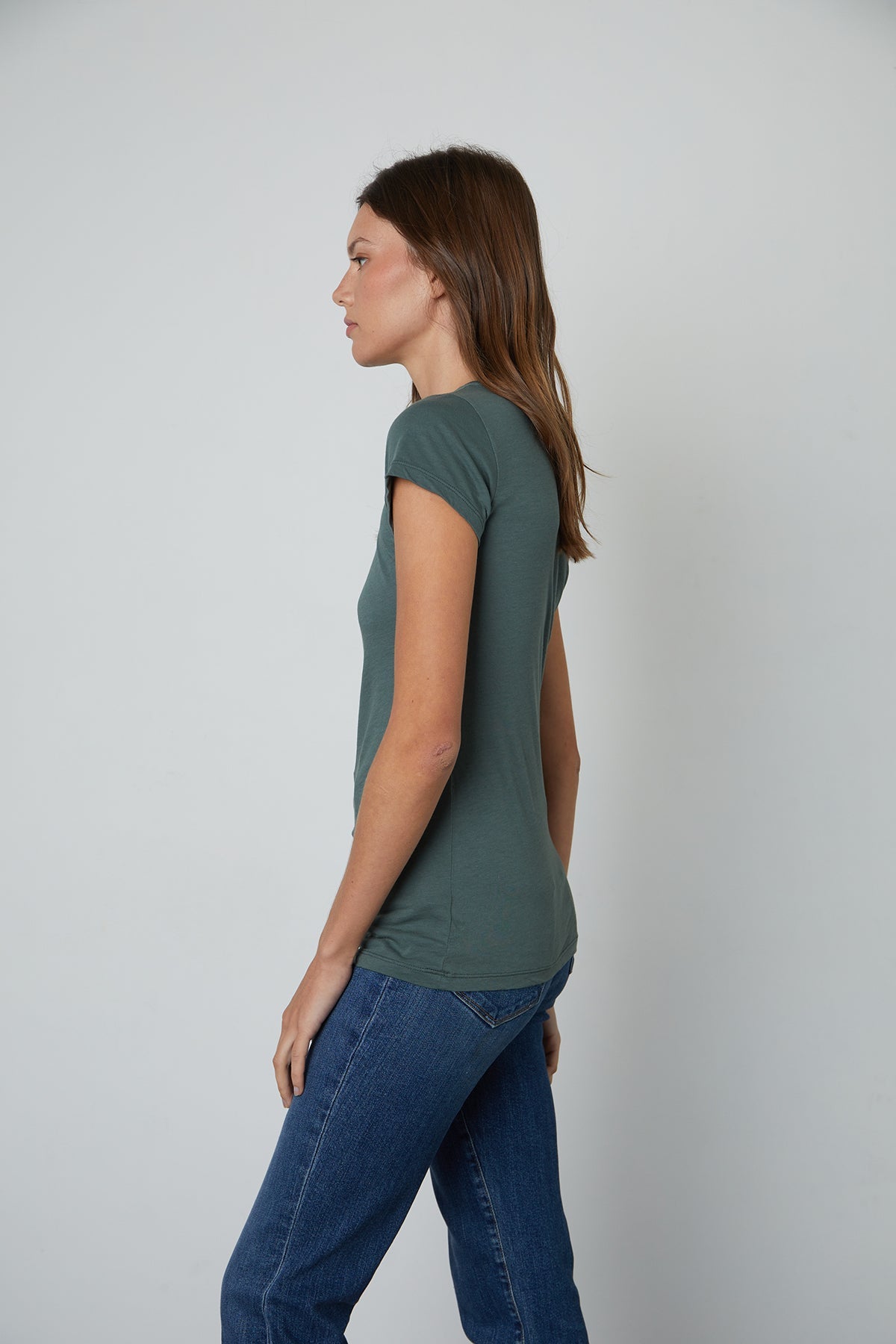   a woman wearing jeans and a Velvet by Graham & Spencer JEMMA GAUZY WHISPER FITTED CREW NECK TEE. 