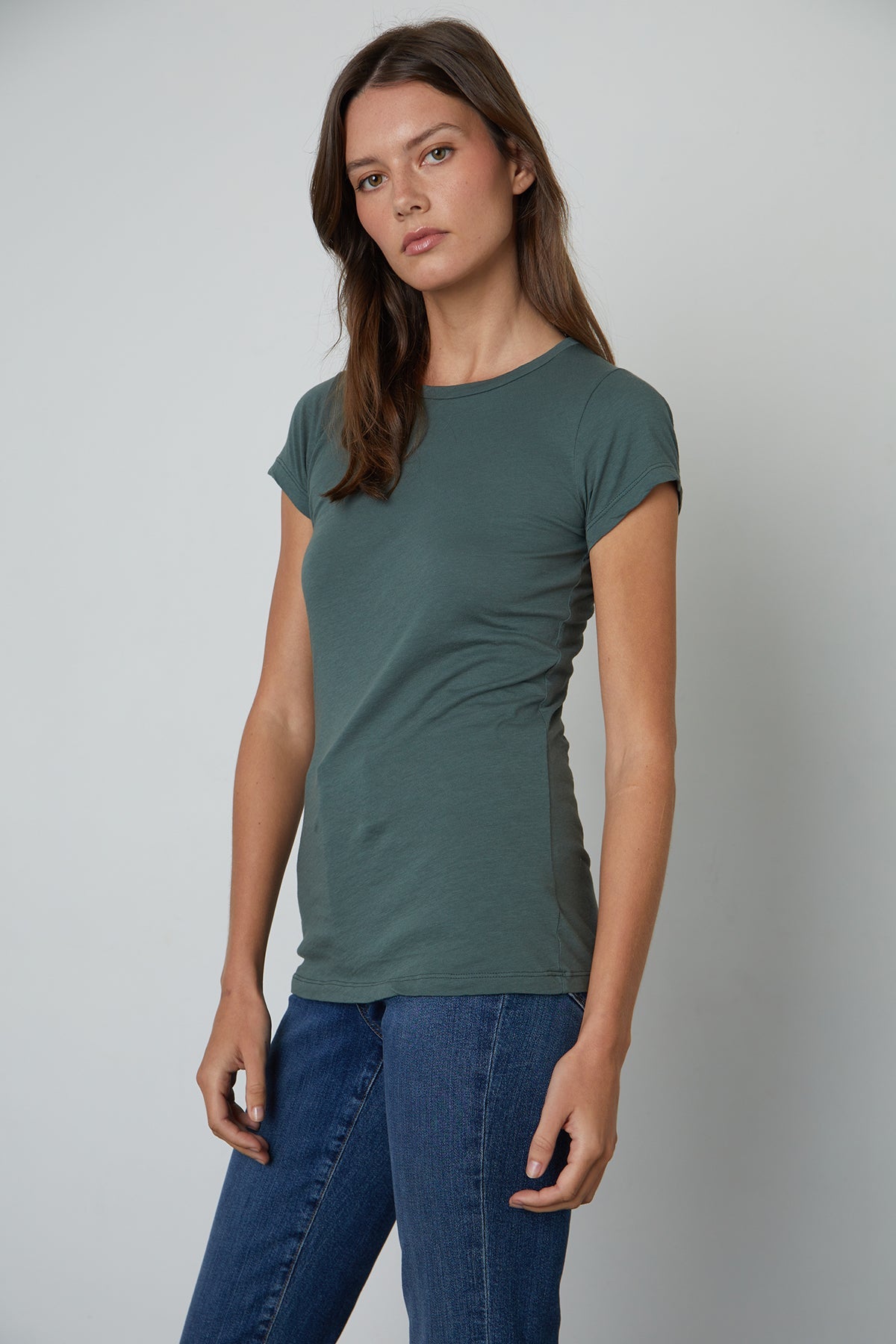   a woman wearing jeans and a Velvet by Graham & Spencer JEMMA GAUZY WHISPER FITTED CREW NECK TEE. 