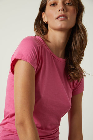 a woman wearing a Velvet by Graham & Spencer JEMMA GAUZY WHISPER FITTED CREW NECK TEE.