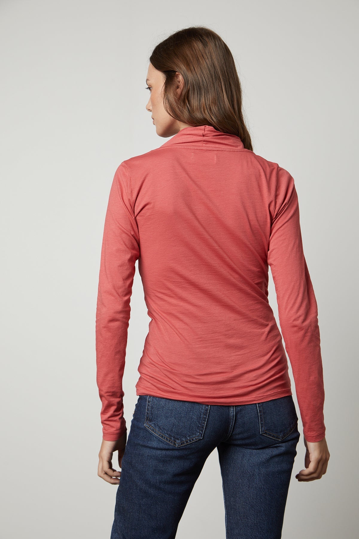 The back view of a woman wearing a Velvet by Graham & Spencer MERI WRAP FRONT FITTED TOP.-35567564456129