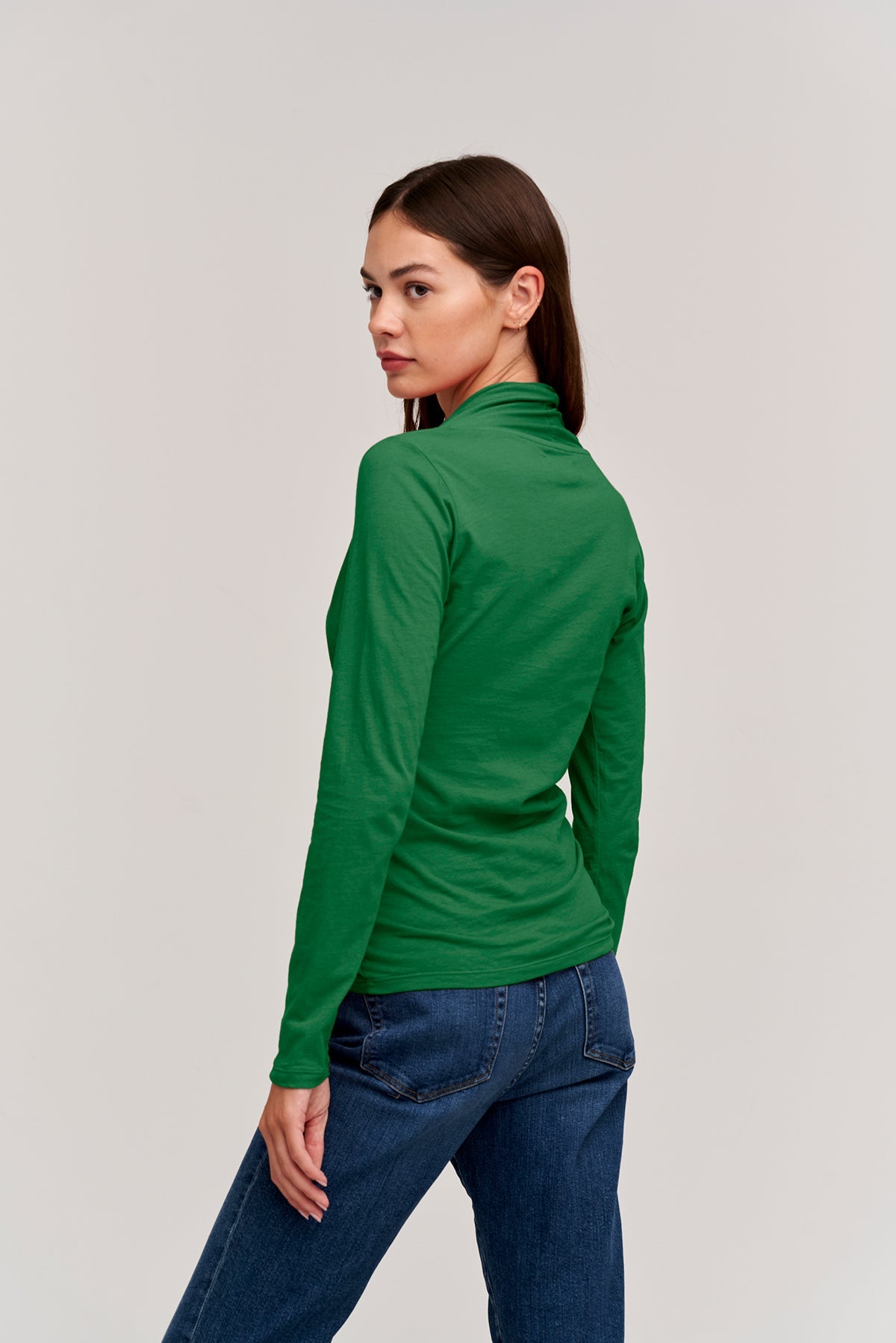   The back view of a woman wearing a Velvet by Graham & Spencer MERI WRAP FRONT FITTED TOP. 
