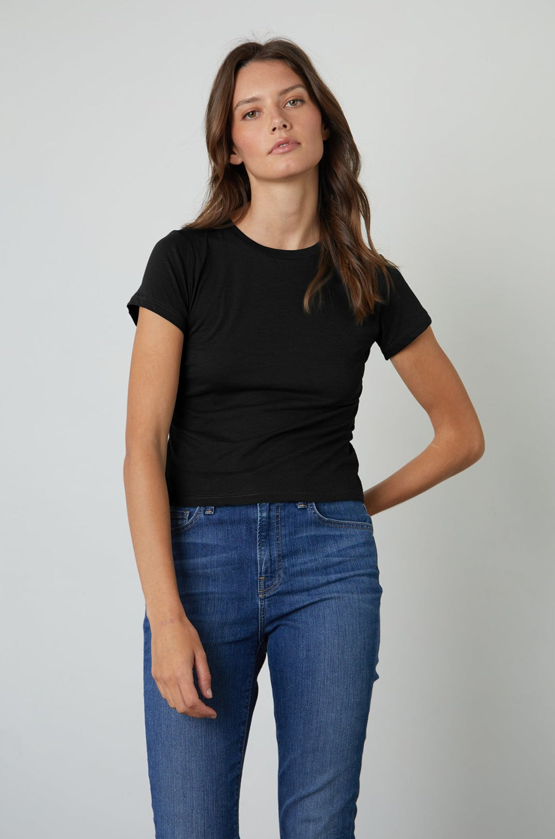 A woman wearing a Velvet by Graham & Spencer NINA CROPPED CREW NECK TEE is a warm-weather special.-35205515804865