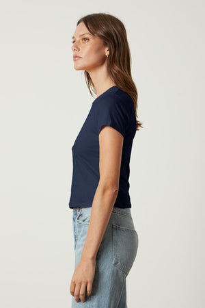 A woman wearing jeans and a Velvet by Graham & Spencer NINA CROPPED CREW NECK TEE.