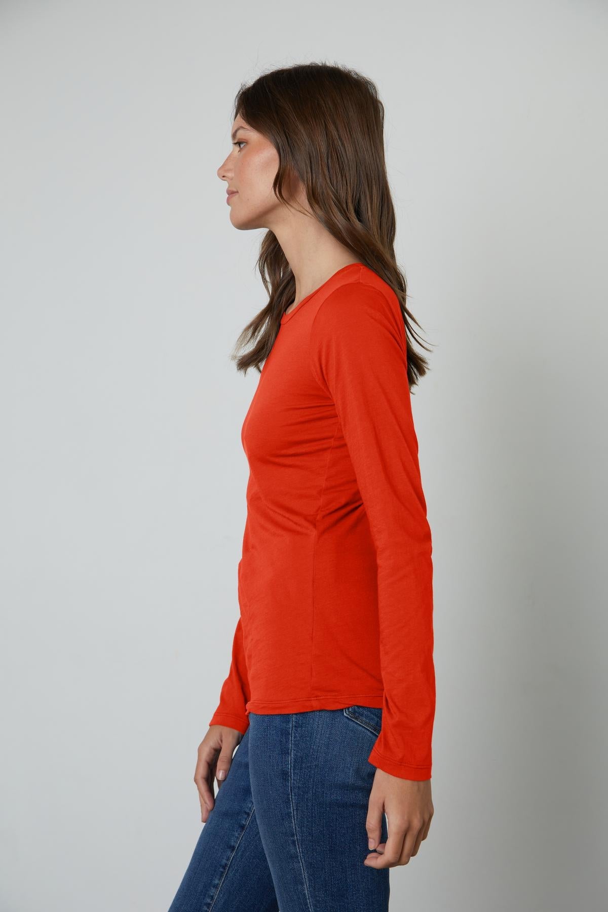A woman wearing a ZOFINA GAUZY WHISPER FITTED CREW NECK TEE from Velvet by Graham & Spencer.-26632448508097