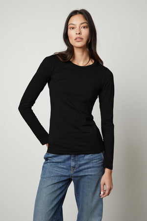 A woman wearing a ZOFINA GAUZY WHISPER FITTED CREW NECK TEE by Velvet by Graham & Spencer.