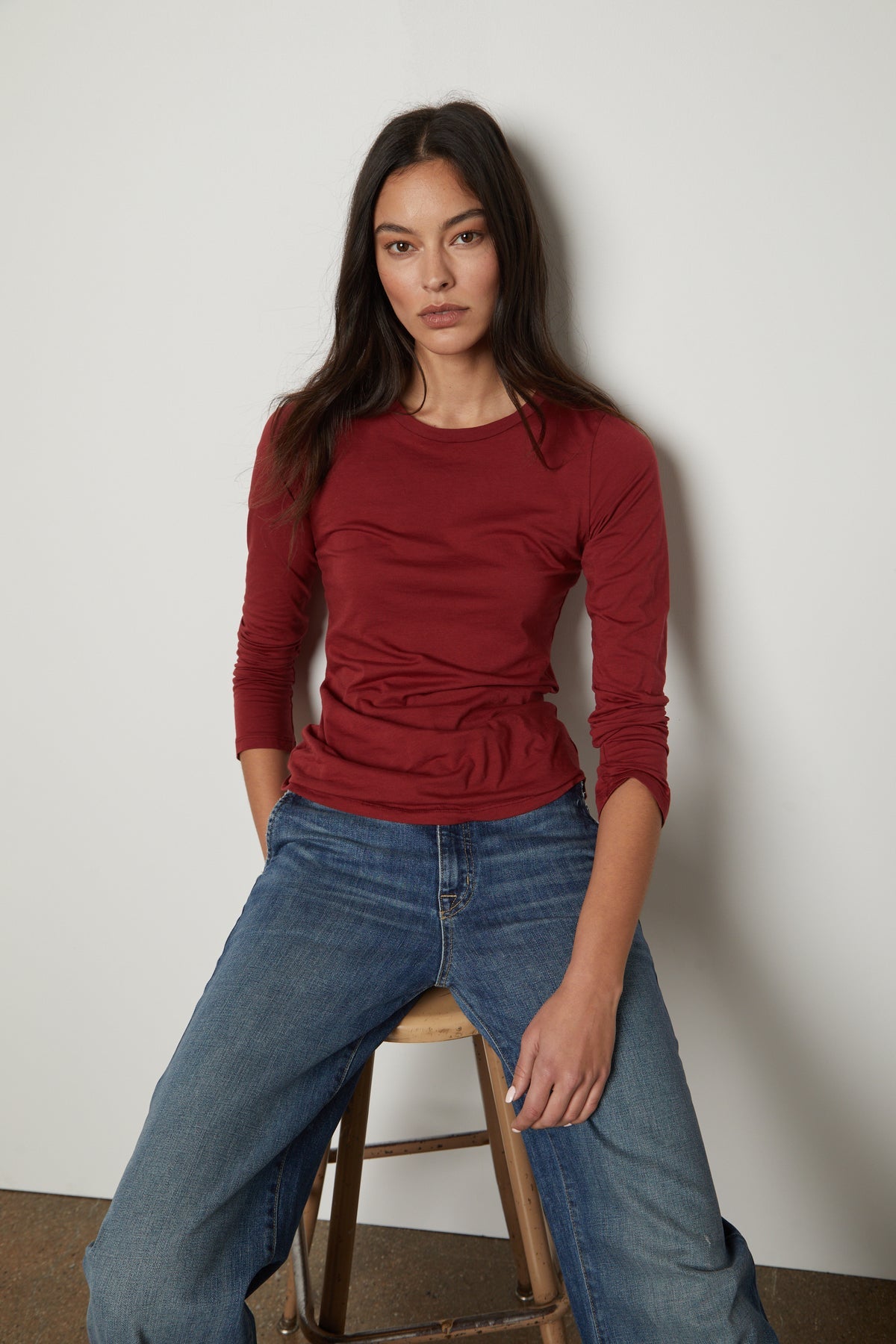   A woman wearing a red ZOFINA GAUZY WHISPER FITTED CREW NECK TEE by Velvet by Graham & Spencer. 
