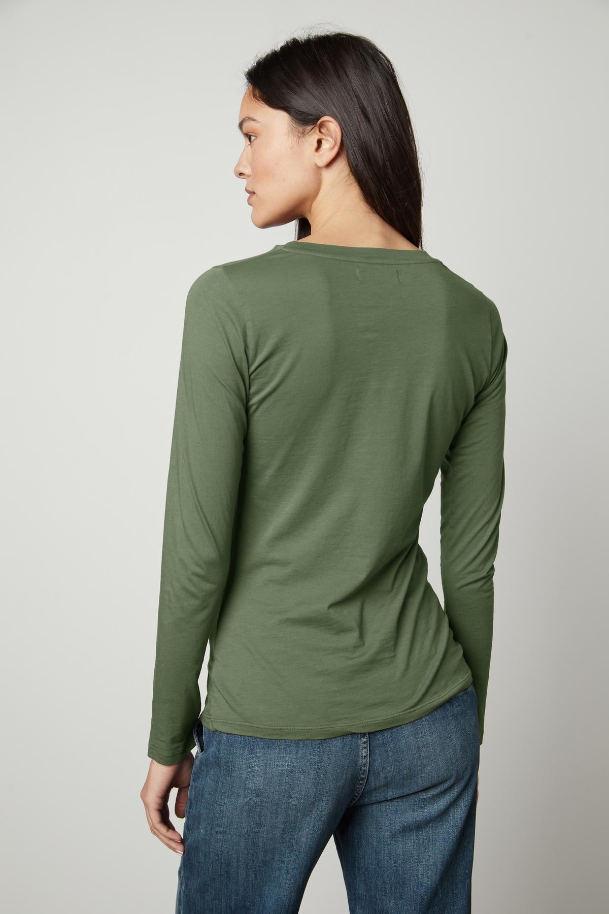 The back view of a person wearing a Velvet by Graham & Spencer ZOFINA GAUZY WHISPER FITTED CREW NECK TEE.-35783262568641