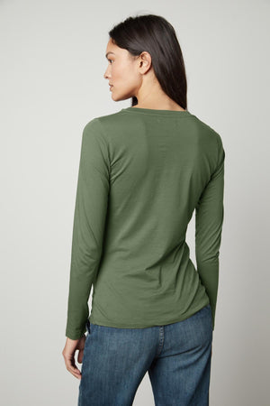 The back view of a person wearing a Velvet by Graham & Spencer ZOFINA GAUZY WHISPER FITTED CREW NECK TEE.