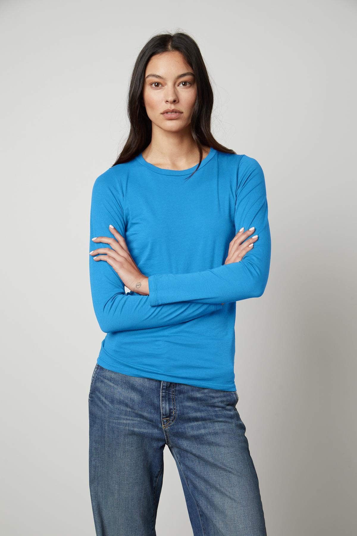 A woman wearing a Velvet by Graham & Spencer ZOFINA GAUZY WHISPER FITTED CREW NECK TEE - perfection.-35503495282881