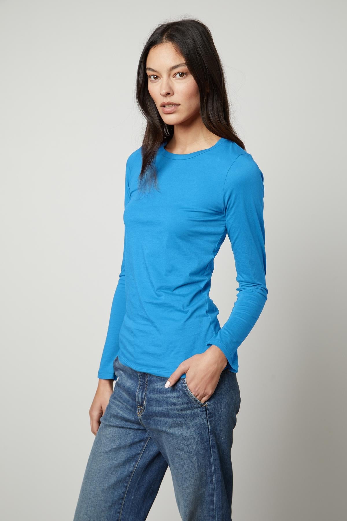 A woman wearing a blue long sleeve ZOFINA GAUZY WHISPER FITTED CREW NECK TEE made from soft gauzy whisper cotton by Velvet by Graham & Spencer.-36594704908481