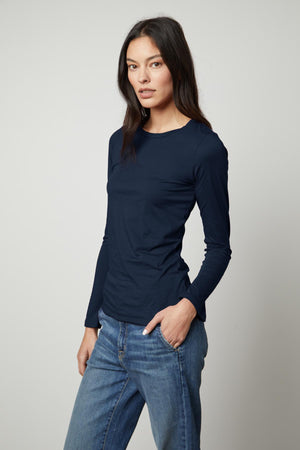 The ZOFINA gauzy whisper fitted crew neck tee by Velvet by Graham & Spencer in navy features a crew neck.