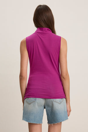 A person is shown from the back against a plain background, wearing the ADELISE WRAP TANK by Velvet by Graham & Spencer in magenta and light blue denim shorts.