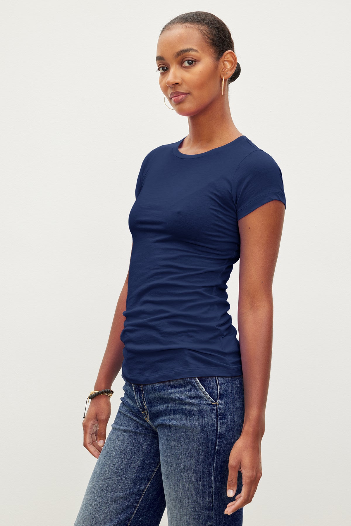   A woman wearing the Velvet by Graham & Spencer JEMMA GAUZY WHISPER FITTED CREW NECK TEE. 