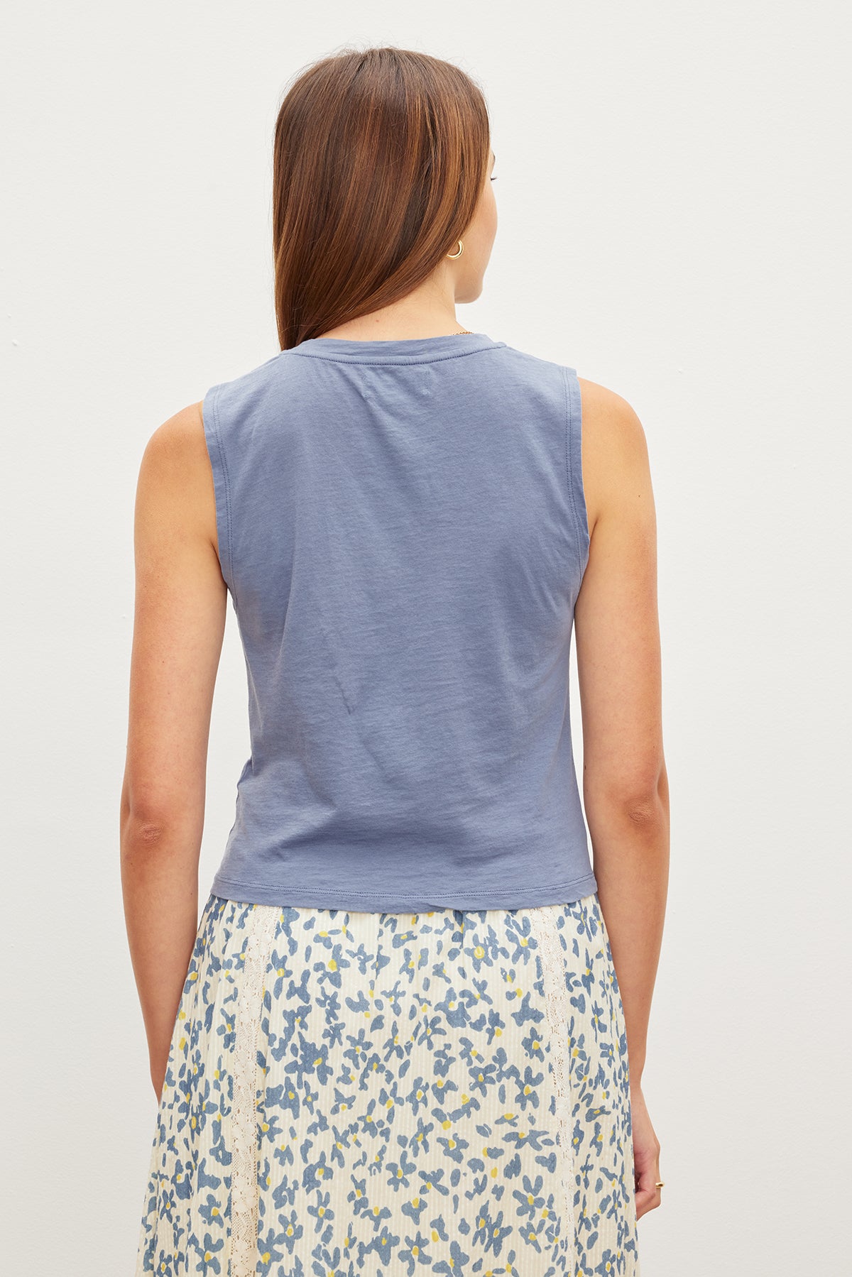   A woman in a trendy Velvet by Graham & Spencer MAGSON CREW NECK TANK TOP. 