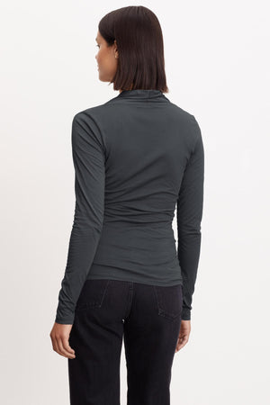 The back view of a woman wearing a Velvet by Graham & Spencer MERI WRAP FRONT FITTED TOP.