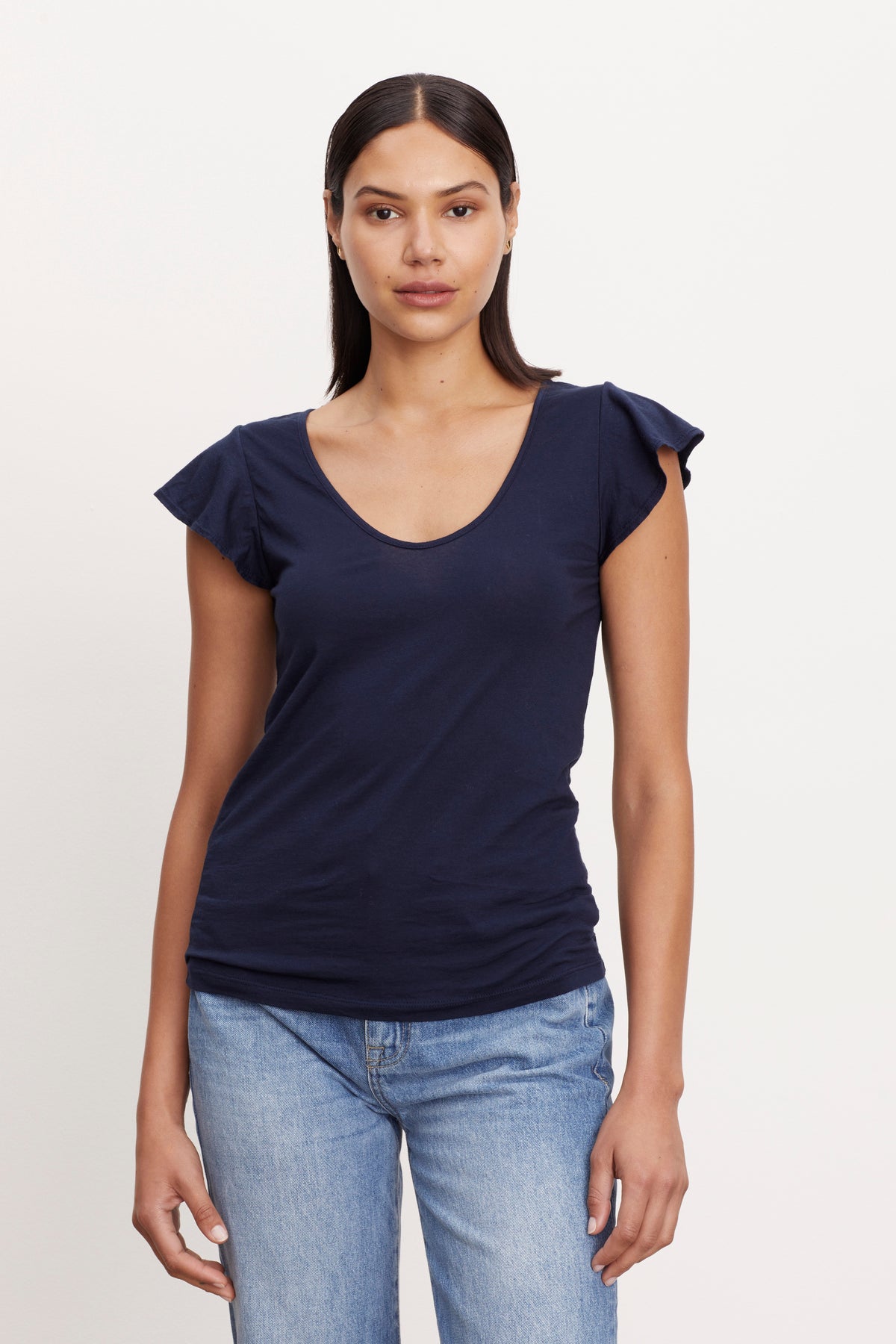   a woman wearing jeans and a Velvet by Graham & Spencer RASHIDA SCOOP NECK TEE. 