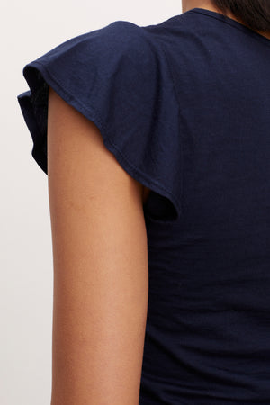 the back view of a woman wearing the Velvet by Graham & Spencer RASHIDA SCOOP NECK TEE with ruffled sleeves.