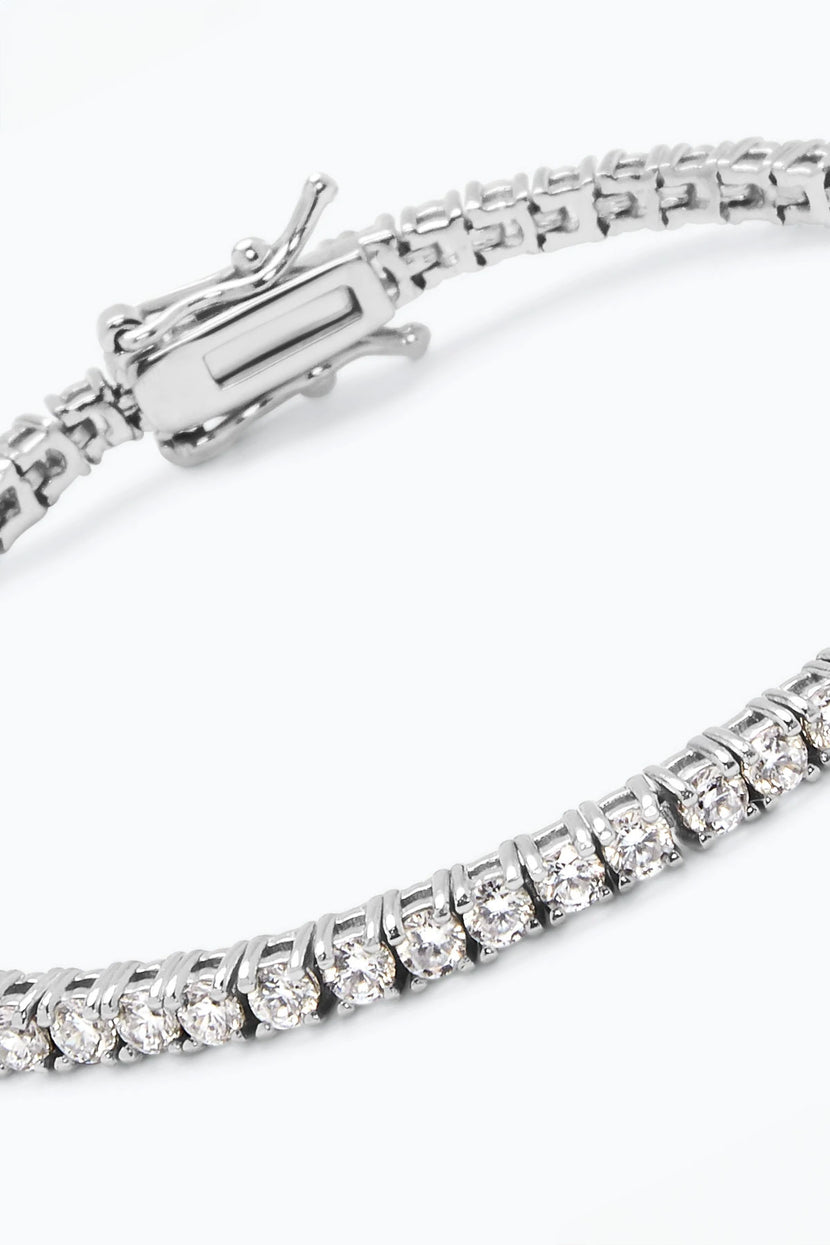 Close up of the Glimmer bracelet by Phyllis and Rosie showcasing silver links, clear gemstones, and a clasp on a white background