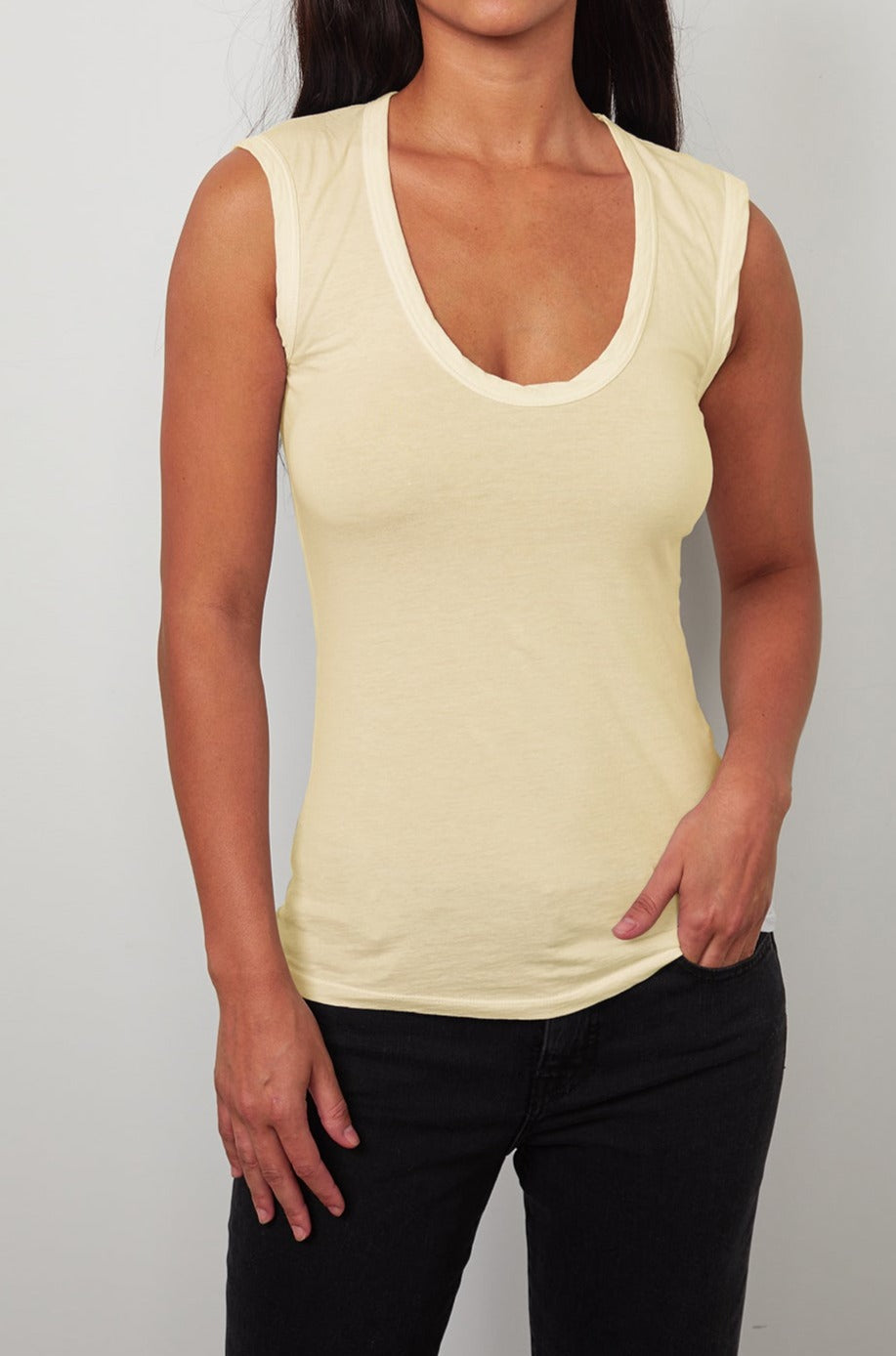 a woman wearing a yellow Velvet by Graham & Spencer ESTINA GAUZY WHISPER FITTED TANK TOP.-26630245810369