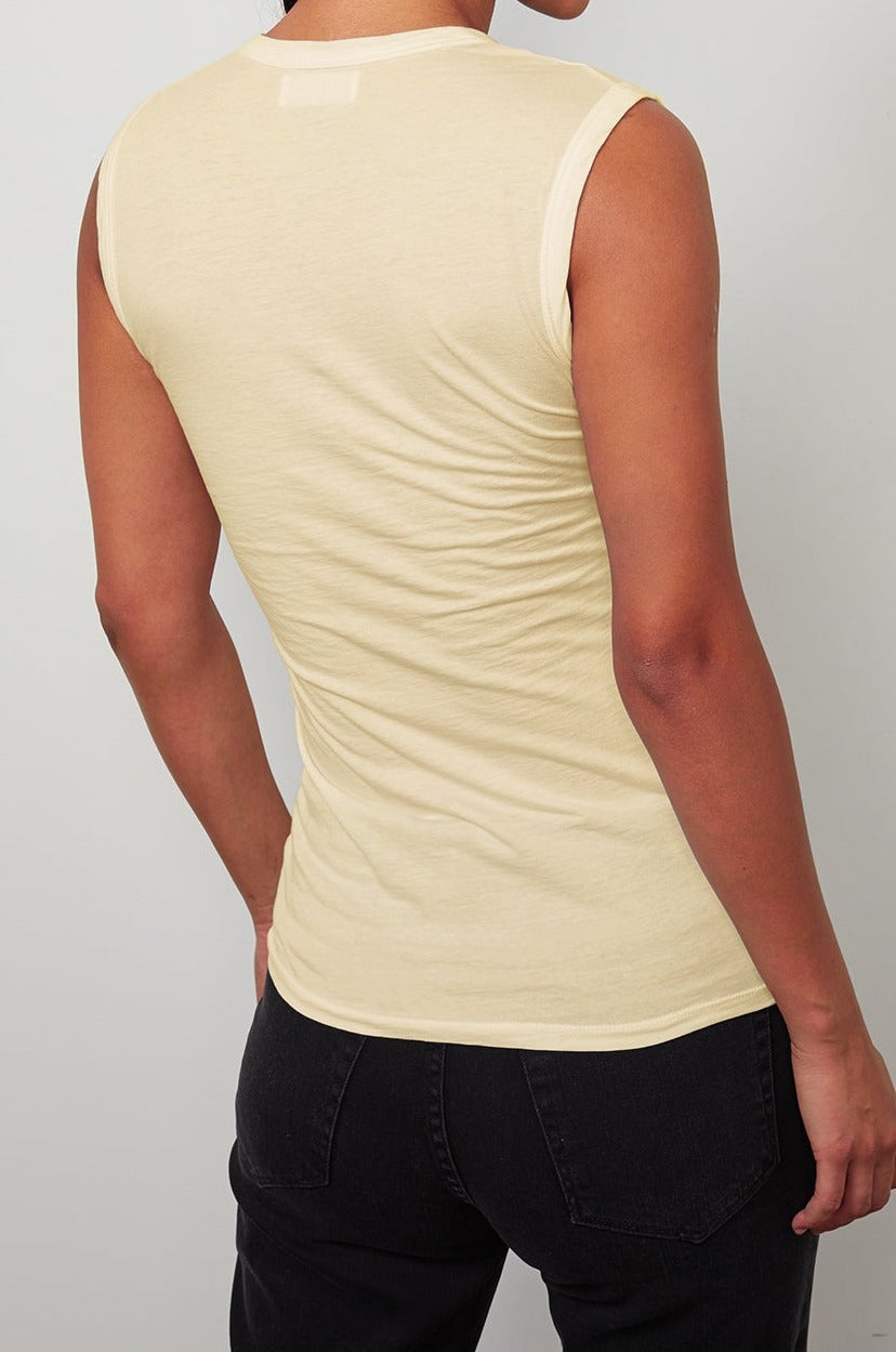 The back view of a woman wearing a Velvet by Graham & Spencer ESTINA GAUZY WHISPER FITTED TANK TOP.-26630245908673