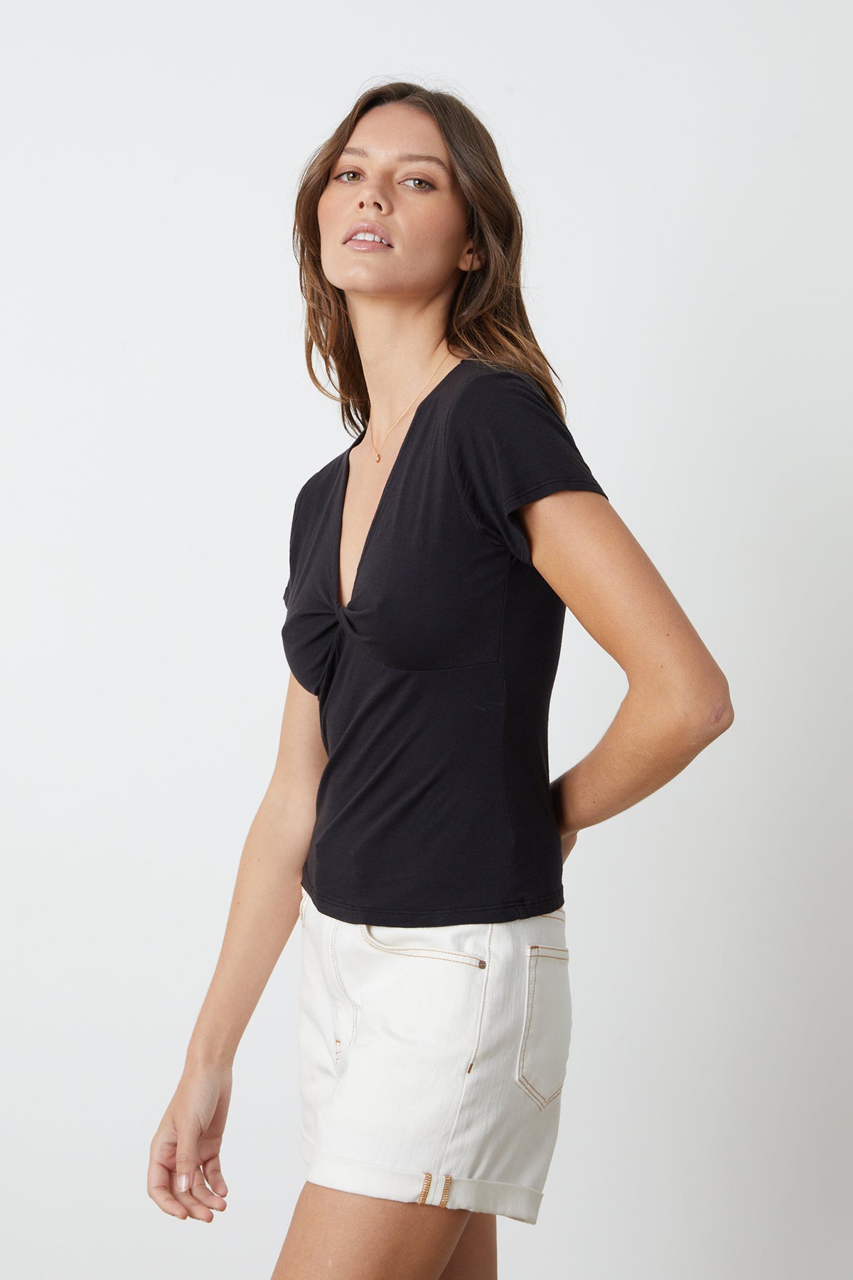 A model wearing a t-shirt and Velvet by Graham & Spencer Natalie Rolled Hem Shorts.-26484786823361